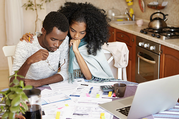 Man and woman reviewing bills